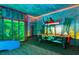 Fun game room with arcade games, air hockey, and colorful wall decor at 1518 Rolling Fairway Dr, Davenport, FL 33896