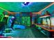 Fun game room with arcade games, air hockey, and colorful wall decor at 1518 Rolling Fairway Dr, Davenport, FL 33896