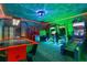 Fun game room with arcade games, air hockey, and colorful wall decor at 1518 Rolling Fairway Dr, Davenport, FL 33896