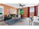 Bright living area with a green sofa, orange accent chair, and fun entryway to a play area at 1518 Rolling Fairway Dr, Davenport, FL 33896