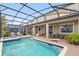 Stunning backyard pool area with covered patio, comfortable seating, and a pristine swimming pool at 1518 Rolling Fairway Dr, Davenport, FL 33896