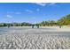 Outdoor sand volleyball court with net, poles and blue sky at 1518 Rolling Fairway Dr, Davenport, FL 33896