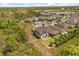 An aerial view of a residential neighborhood, showcasing home with solar panels and brick driveway at 1559 Scrub Jay Ct, Deland, FL 32724