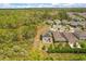 Aerial view of home with solar panels and patio in a neighborhood surrounded by a natural landscape at 1559 Scrub Jay Ct, Deland, FL 32724