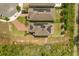 An aerial view of a home with solar panels, a brick patio and driveway in a residential area at 1559 Scrub Jay Ct, Deland, FL 32724