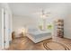 Bright bedroom featuring a neutral palette, ceiling fan, and stylish herringbone wood floors at 1559 Scrub Jay Ct, Deland, FL 32724
