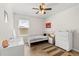 Bright bedroom with modern décor including desk, dresser, ceiling fan, and a window at 1559 Scrub Jay Ct, Deland, FL 32724