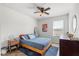 Airy bedroom with a ceiling fan, window and sleek furnishings in a relaxing setting at 1559 Scrub Jay Ct, Deland, FL 32724