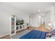 Cozy bonus room with stylish herringbone floors, TV and bookcase at 1559 Scrub Jay Ct, Deland, FL 32724