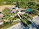 Aerial view of community center with pool, palm trees, and ample parking for residents' enjoyment at 1559 Scrub Jay Ct, Deland, FL 32724