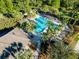 Aerial shot showcasing a beautiful community pool surrounded by palm trees and lounge chairs at 1559 Scrub Jay Ct, Deland, FL 32724