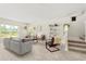 Open-concept living room with lots of natural light, soft carpet and stylish decor at 1559 Scrub Jay Ct, Deland, FL 32724