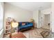 Sitting room featuring a unique blue velvet sofa, shelving, and bright natural light at 1559 Scrub Jay Ct, Deland, FL 32724
