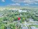 Aerial view of the home and neighborhood, marked with a location pin, close to a beautiful lake at 1621 Highland Dr, Longwood, FL 32750