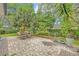 Relaxing backyard patio with table and chairs surrounded by lush tropical landscaping at 1621 Highland Dr, Longwood, FL 32750