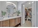 Bright bathroom with wood vanity and large mirror and a walk in closet at 1621 Highland Dr, Longwood, FL 32750