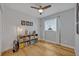 Cozy bedroom features wood floors, ceiling fan, and a shelving unit with books and decorations at 1621 Highland Dr, Longwood, FL 32750