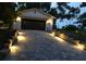 Well-lit driveway and garage at dusk provide a welcoming entrance to the home at 1621 Highland Dr, Longwood, FL 32750