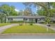 Charming home featuring a well-manicured lawn and a circular driveway, adding to its curb appeal at 1621 Highland Dr, Longwood, FL 32750