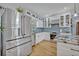 Modern white kitchen featuring stainless steel appliances, granite countertops, and ample cabinet space at 1621 Highland Dr, Longwood, FL 32750