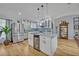Modern white kitchen featuring stainless steel appliances, granite countertops, and ample cabinet space at 1621 Highland Dr, Longwood, FL 32750