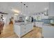 Spacious white kitchen with large island featuring granite countertops and modern stainless steel appliances at 1621 Highland Dr, Longwood, FL 32750