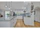 Bright kitchen featuring white cabinets, stainless steel appliances, granite countertops, and a wine rack at 1621 Highland Dr, Longwood, FL 32750