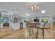 Bright, open-concept living space with hardwood floors and a modern kitchen with granite countertops at 1621 Highland Dr, Longwood, FL 32750