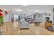 Bright, open living area with hardwood floors, featuring a modern kitchen and multiple seating areas at 1621 Highland Dr, Longwood, FL 32750