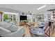 Bright living room featuring hardwood floors, a skylight, and comfortable seating at 1621 Highland Dr, Longwood, FL 32750