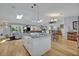 Open-concept living area boasts hardwood floors and a modern kitchen with a large granite island at 1621 Highland Dr, Longwood, FL 32750