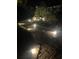 Illuminated backyard walkway at night, surrounded by lush landscaping and serene ambiance at 1621 Highland Dr, Longwood, FL 32750