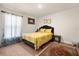 Cozy bedroom with a large window and floral bedding, with decorative art at 1645 Denali St, Davenport, FL 33837