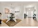 Bright dining area with modern chandelier, sleek white chairs and view to foyer at 1645 Denali St, Davenport, FL 33837