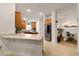 Open-concept kitchen featuring a breakfast bar, stainless steel appliances, and a view of the dining area at 1645 Denali St, Davenport, FL 33837