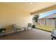 Relaxing covered patio with neutral colors and comfortable seating, perfect for outdoor enjoyment at 1645 Denali St, Davenport, FL 33837