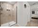 Walk-in shower with tile surround and glass doors, adjacent to doorway to main bedroom at 1645 Denali St, Davenport, FL 33837
