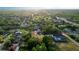 An aerial view of a tree-lined neighborhood and the home surrounded by mature trees and landscaping at 170 Blaine St, Eustis, FL 32726