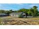 Home's backyard with land and driveway leading up to the 2 car garage at 170 Blaine St, Eustis, FL 32726