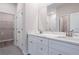 Bathroom with double sinks, white cabinets, and a large mirror at 170 Blaine St, Eustis, FL 32726