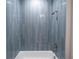 Stylish bathroom with blue tiled shower and white bathtub at 170 Blaine St, Eustis, FL 32726