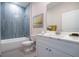 Well-lit bathroom with marble countertop, white cabinets, and tile shower at 170 Blaine St, Eustis, FL 32726