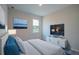 Furnished bedroom featuring a window and large television at 170 Blaine St, Eustis, FL 32726