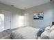 Bedroom featuring bed with plush bedding, mountain artwork, and wood-look flooring at 170 Blaine St, Eustis, FL 32726