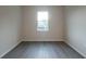 Empty bedroom with neutral walls and flooring showcases a window view and electrical outlets at 170 Blaine St, Eustis, FL 32726