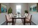 A stylish dining room features a glass-top table, seating for six, and modern decor at 170 Blaine St, Eustis, FL 32726