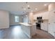 Bright, open kitchen with stainless steel appliances, large center island and modern pendant lighting at 170 Blaine St, Eustis, FL 32726