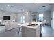Bright open-concept kitchen with modern island, stainless steel faucet, and pendant lighting at 170 Blaine St, Eustis, FL 32726