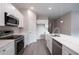 Modern kitchen featuring stainless steel appliances, white cabinets, and a stylish island at 170 Blaine St, Eustis, FL 32726