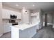 Modern kitchen featuring stainless steel appliances, white cabinets, and a stylish island at 170 Blaine St, Eustis, FL 32726